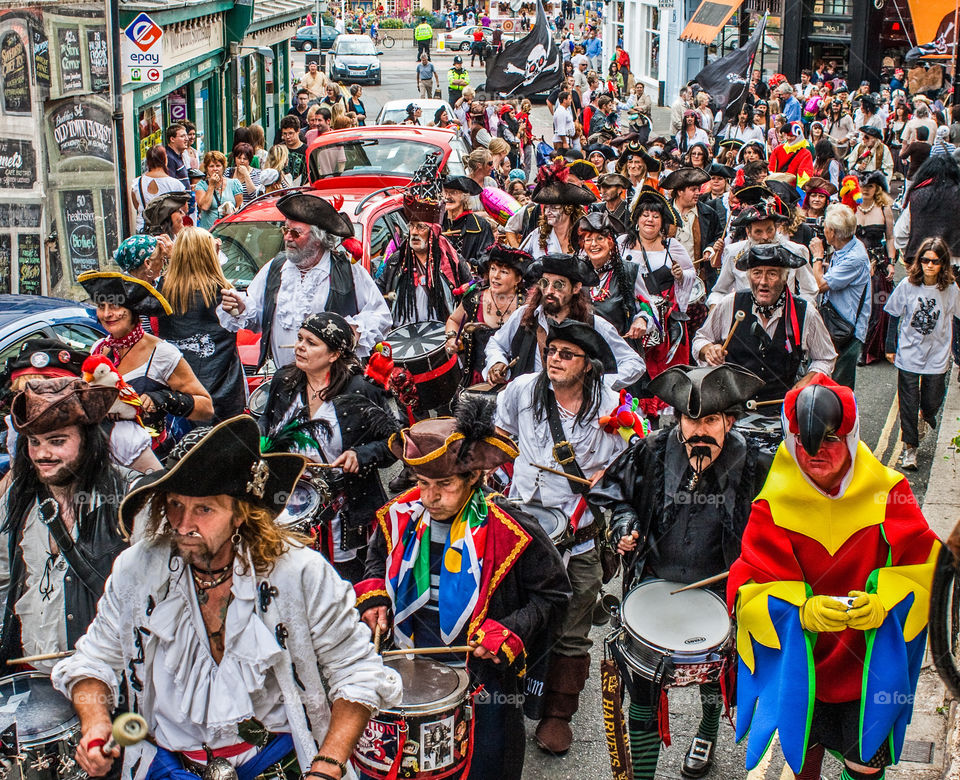 A huge procession of Pirate and drummers and even at parrot, march up the High Street at Hastings Pirate Day