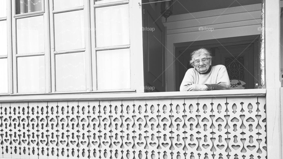 Senior woman standing in balcony