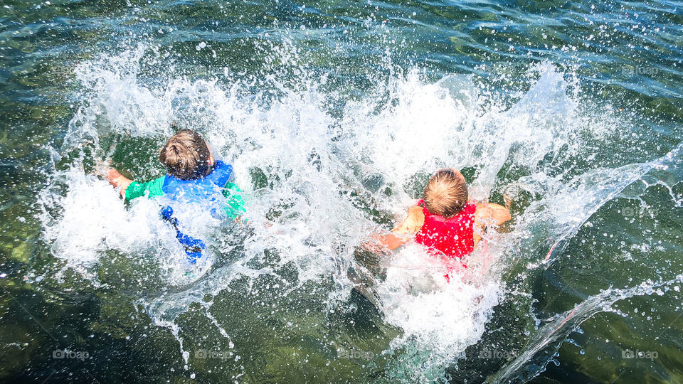 Kids jumping into a lake 