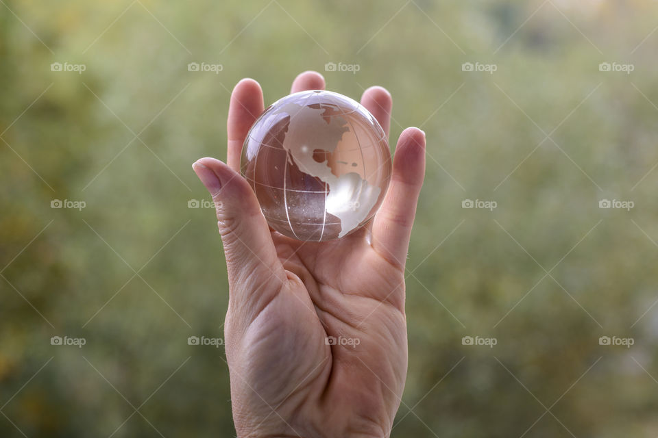 transparent globe in hand