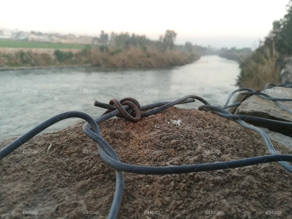 The wire that was tied beside the river and the river passage going to the far sea.