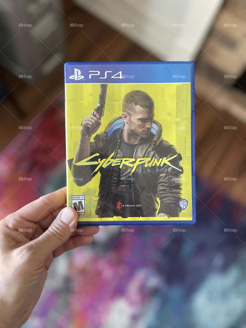 Woman’s hand holding Cyberpunk ps4 game, playing video games, holding video games in woman’s hand, hand holding PS4 games, PlayStation games for Christmas 