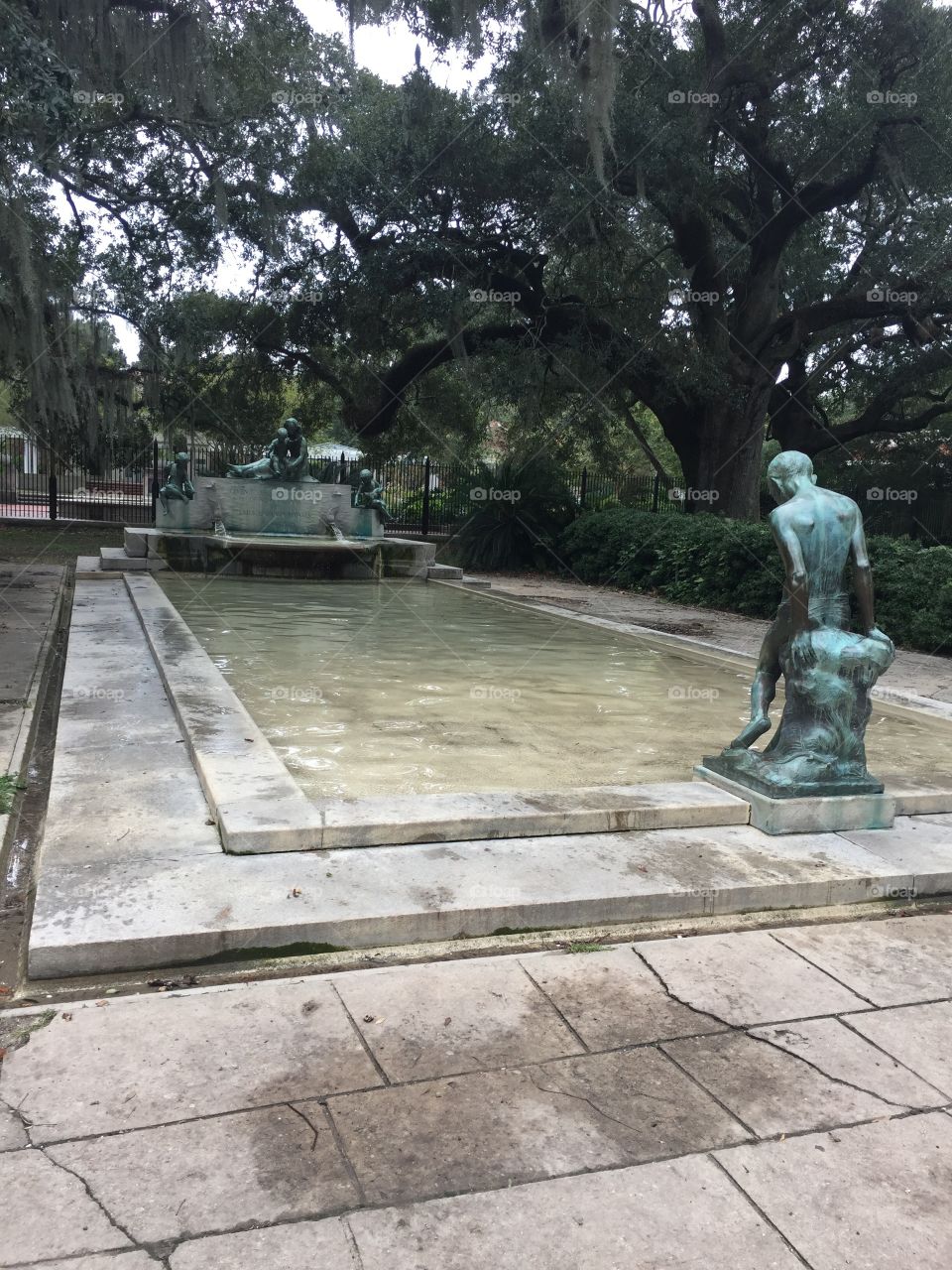 New Orleans weathered memorial bronze statues sitting in the quiet shade of this park