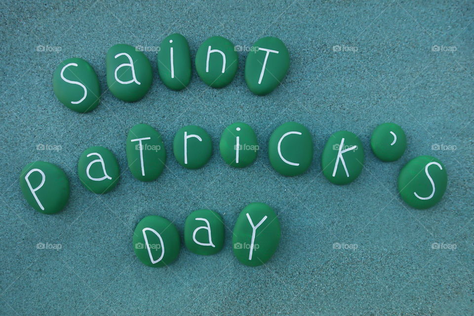 Saint Patrick's day with green painted stones over green sand