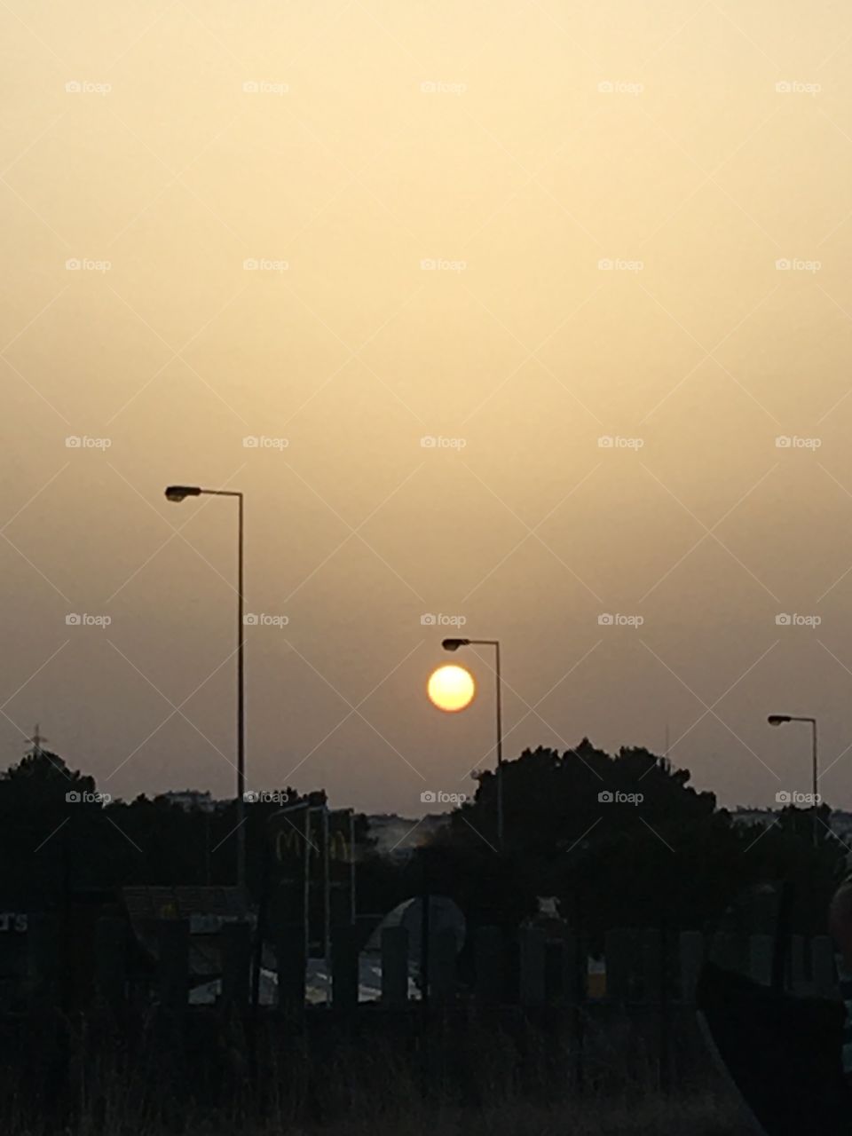 Sun or Moon in the city sky 