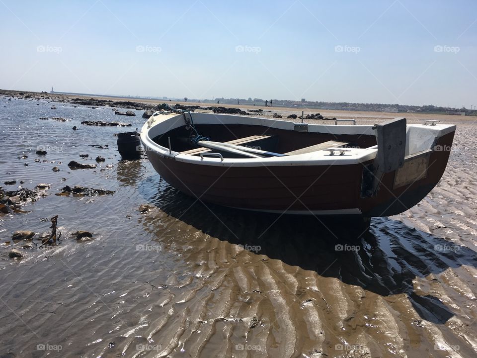 Lone boat at low tide