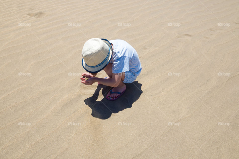 Boy playing in the sand