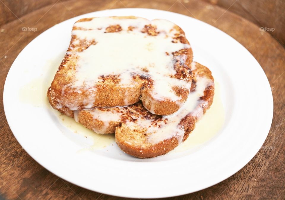churrs French toast drizzled with a custard sauce