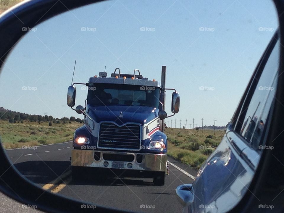 Truck reflected on the rearview mirror