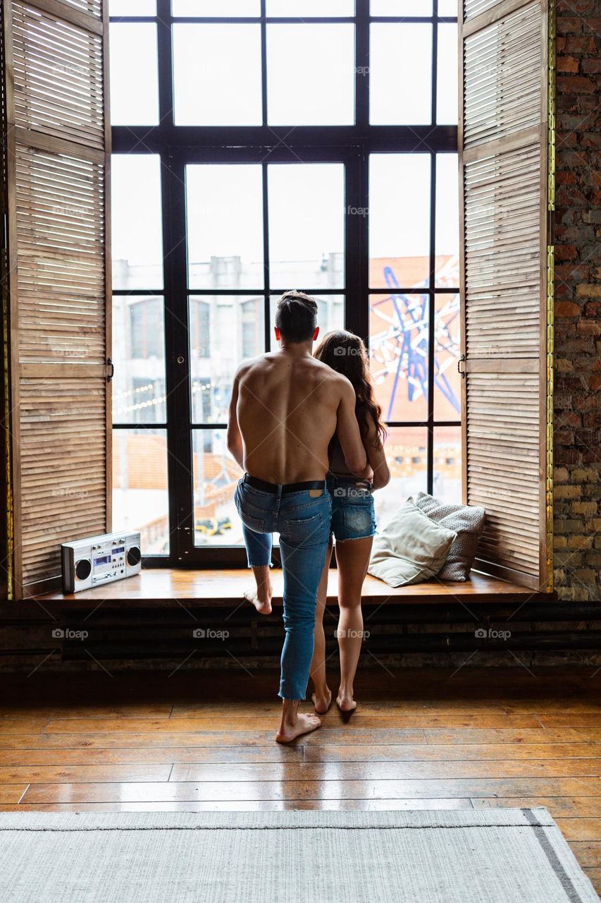 Couple in love near window 