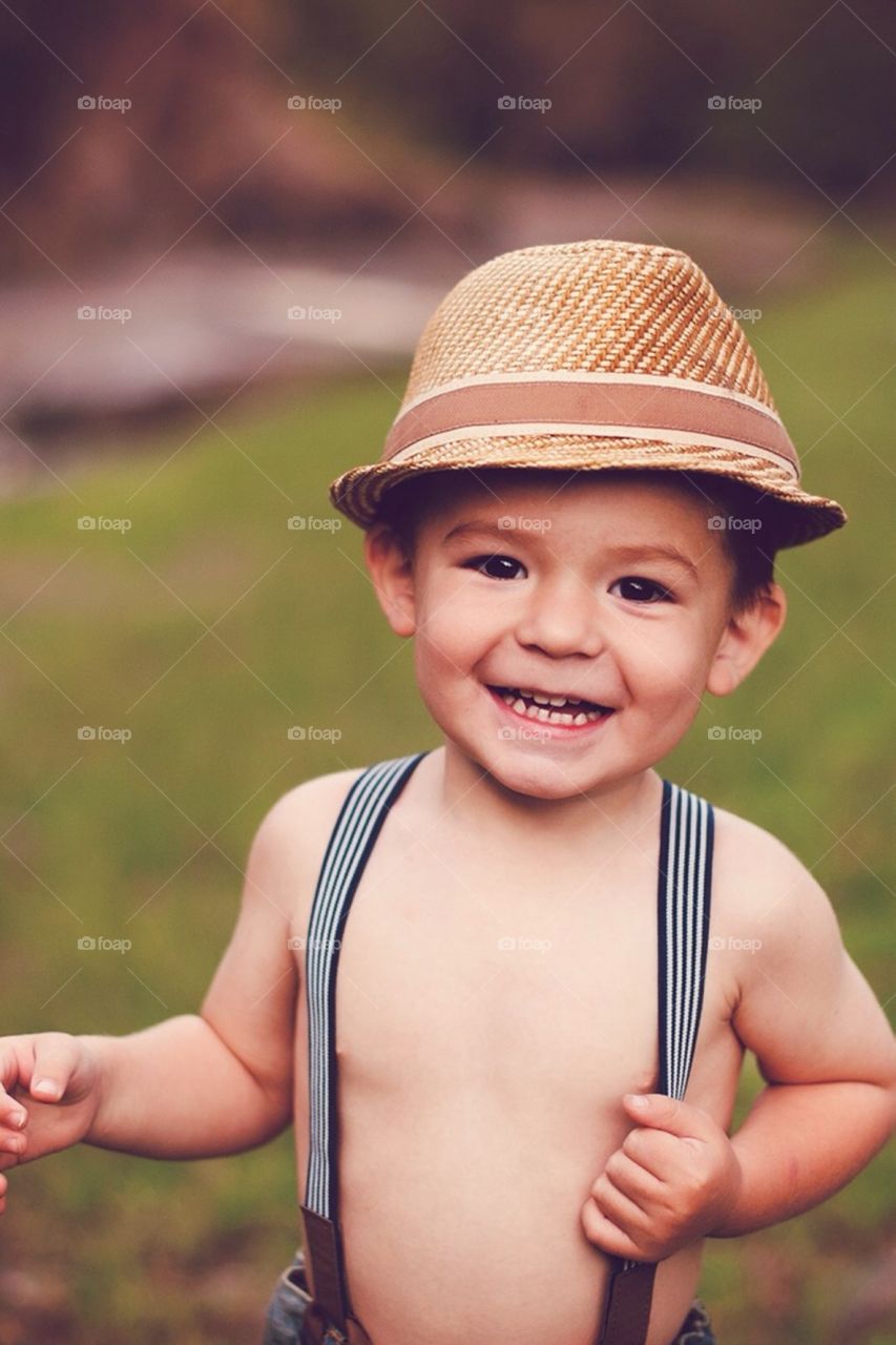 Portrait of cute boy smiling and wearing hat