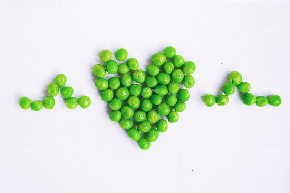 Heart shape made from green peas