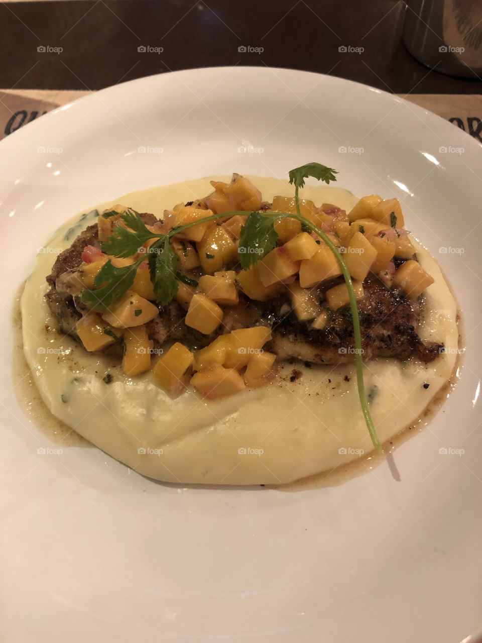 Typical Brazilian dish with fresh fish from the river, smashed manioc and mango