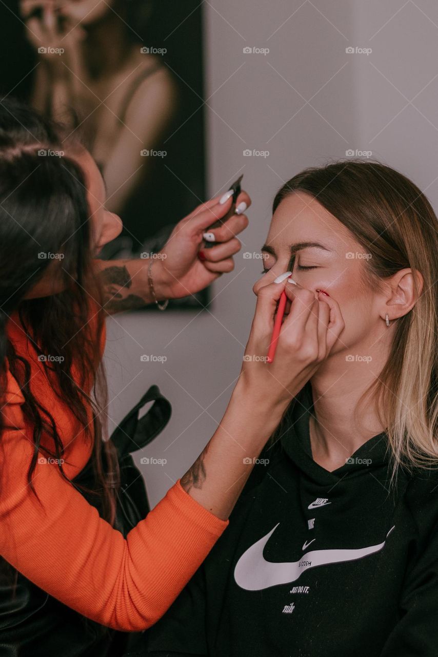 Make up artist, woman, applying products, eyebrows