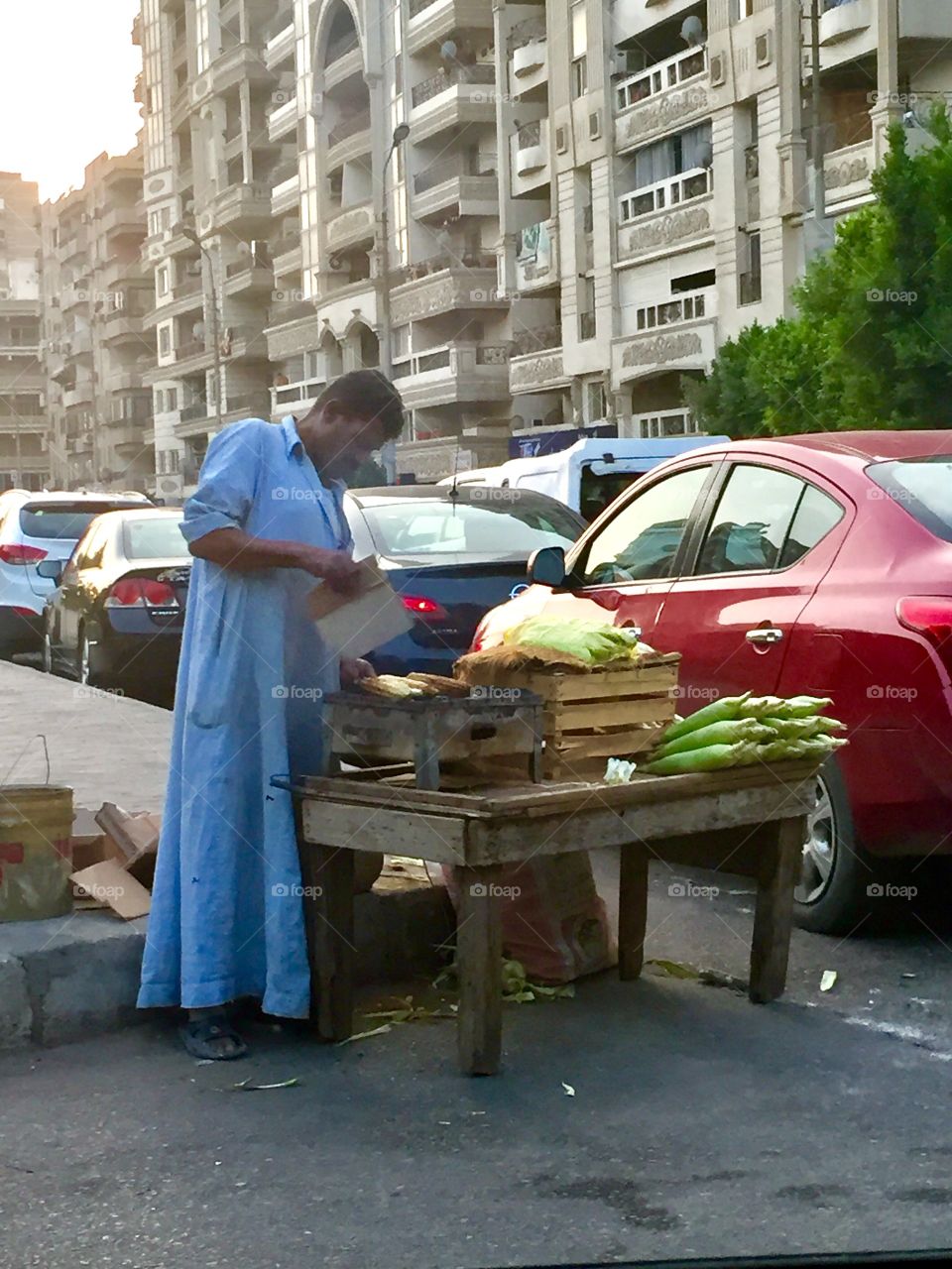 Old man selling grill corn by the roadside 