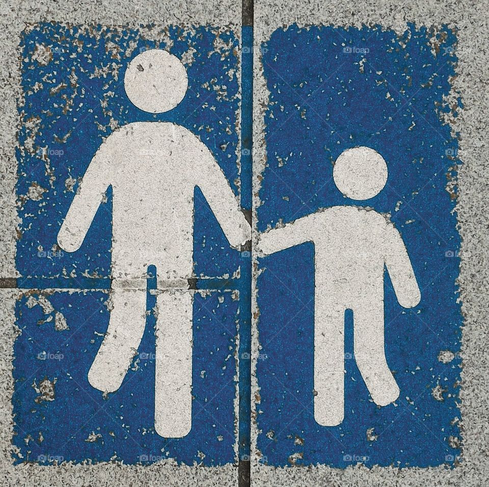 Adult and a child holding hands and walking