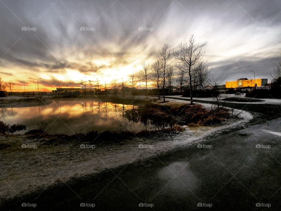 The weather and temperature is changing getting into winter. The sun is setting on a beautifully cold day. In the distance the University of Iceland reflects the moment.