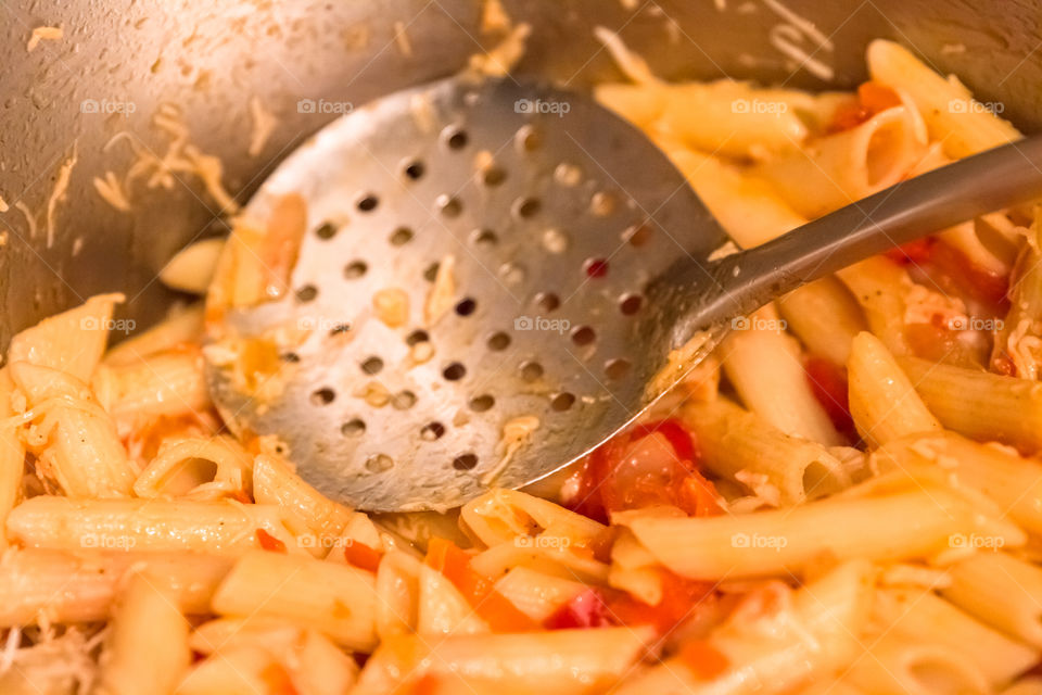 Cooking Penne Pasta Macaroni With Tomato Sauce In A Pot
