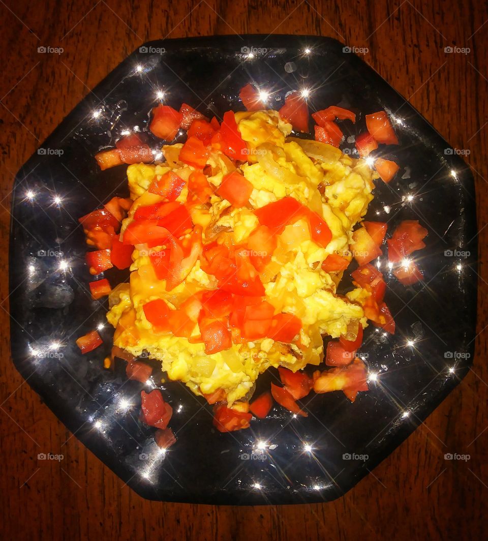 Scrambled eggs with cheese, sauteed onions, and fresh chopped tomatoes.