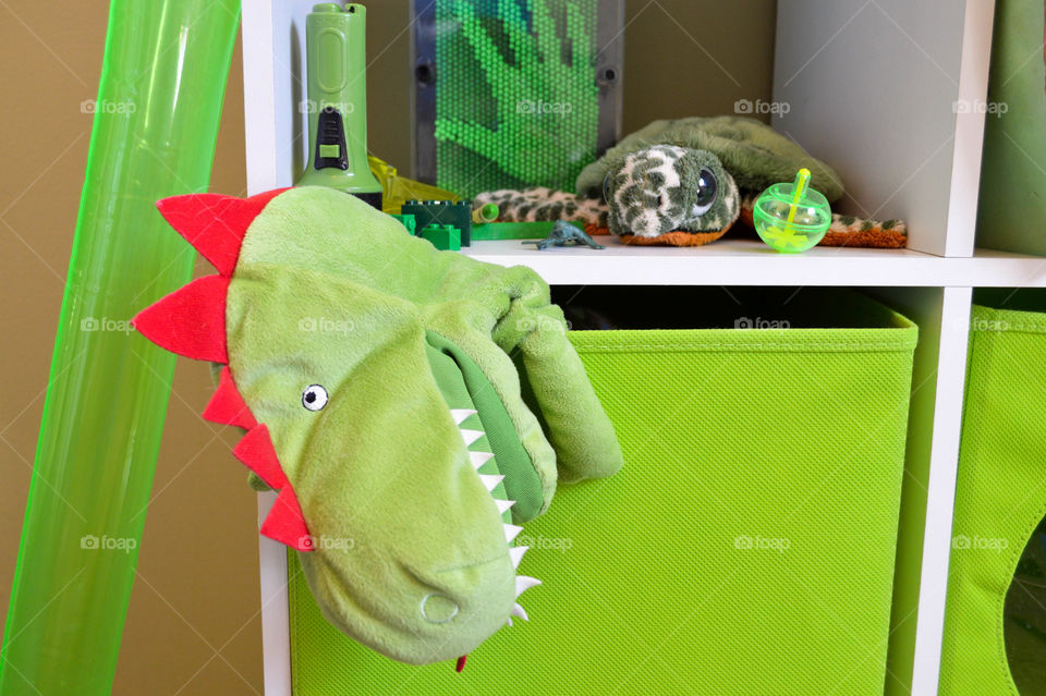 Green children's toys on a shelf