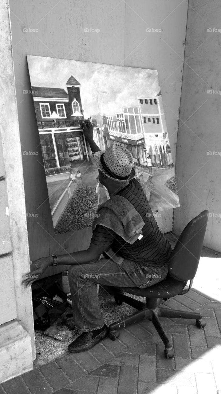 Black and white View of man painting.. Key West