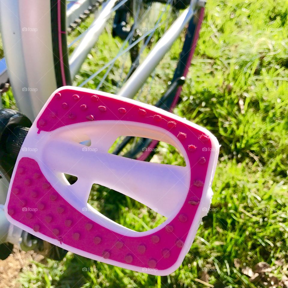 Close-up of pink bicycle peadl