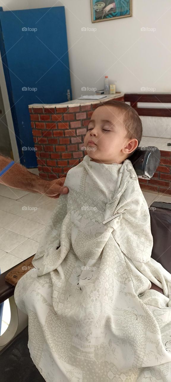 Boy falls asleep while cutting his hair