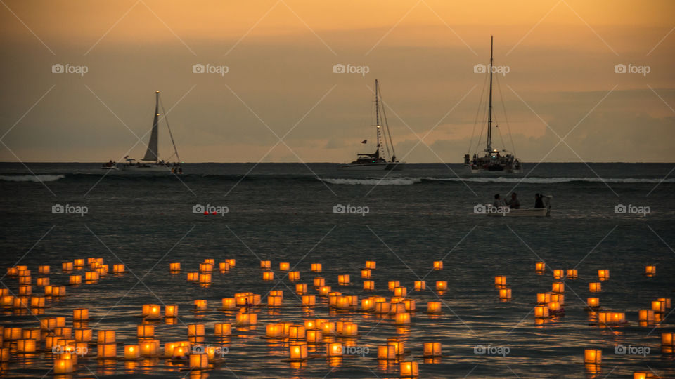Hawaiian Memorial Day lanterns. Lanterns floating at ala moan beach park Hawaii Oahu island. Memorial Day ceremony during the magic hour
