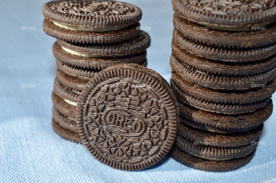 A stack of Oreo cookies on a blue background