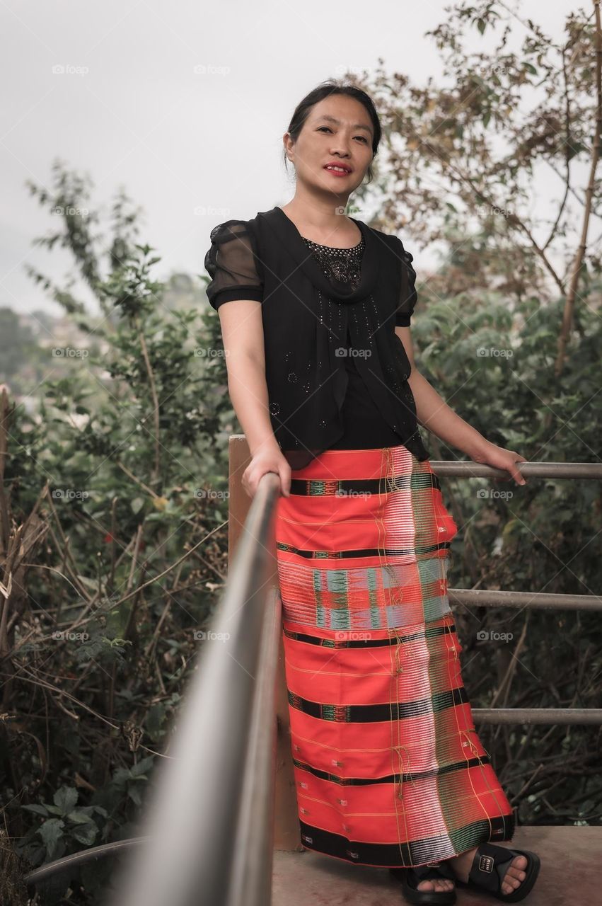 A Tangkhul Naga mother in her traditional attire, wearing the traditional sarong of the tangkhul naga tribe.