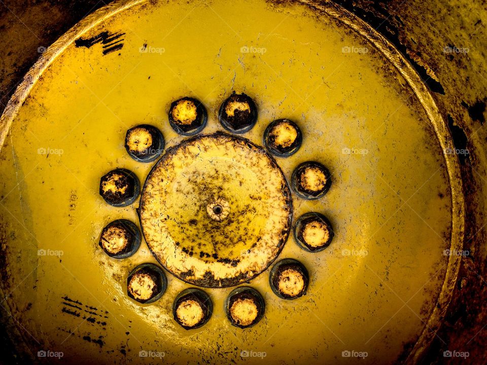 Lug nuts and wheel hub cap of a tractor