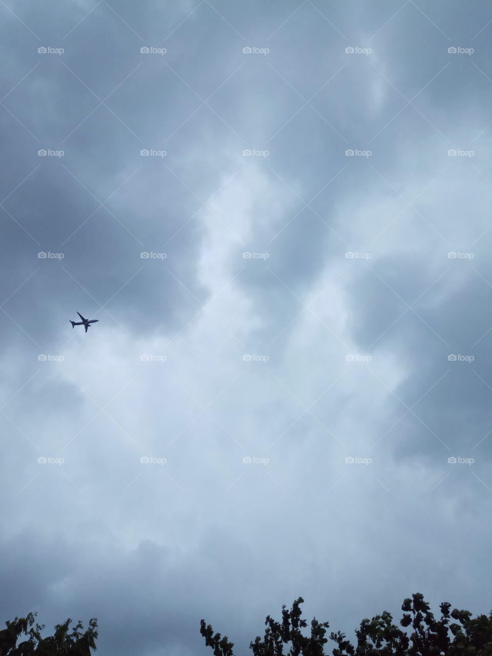 airplane under the cloudy sky