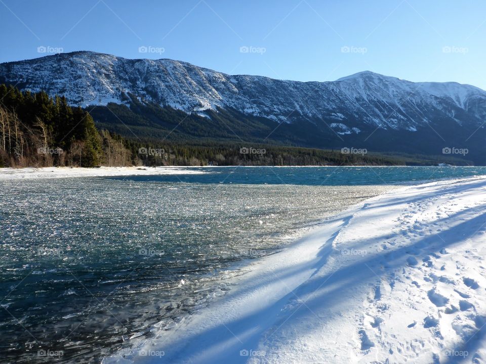 View of mountain and lake in snowy weather