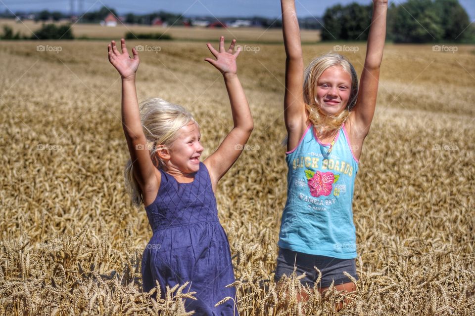 Smiling sister standing in field