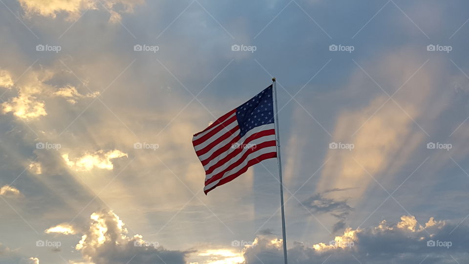 American flag. American flag with a sunset backdrop