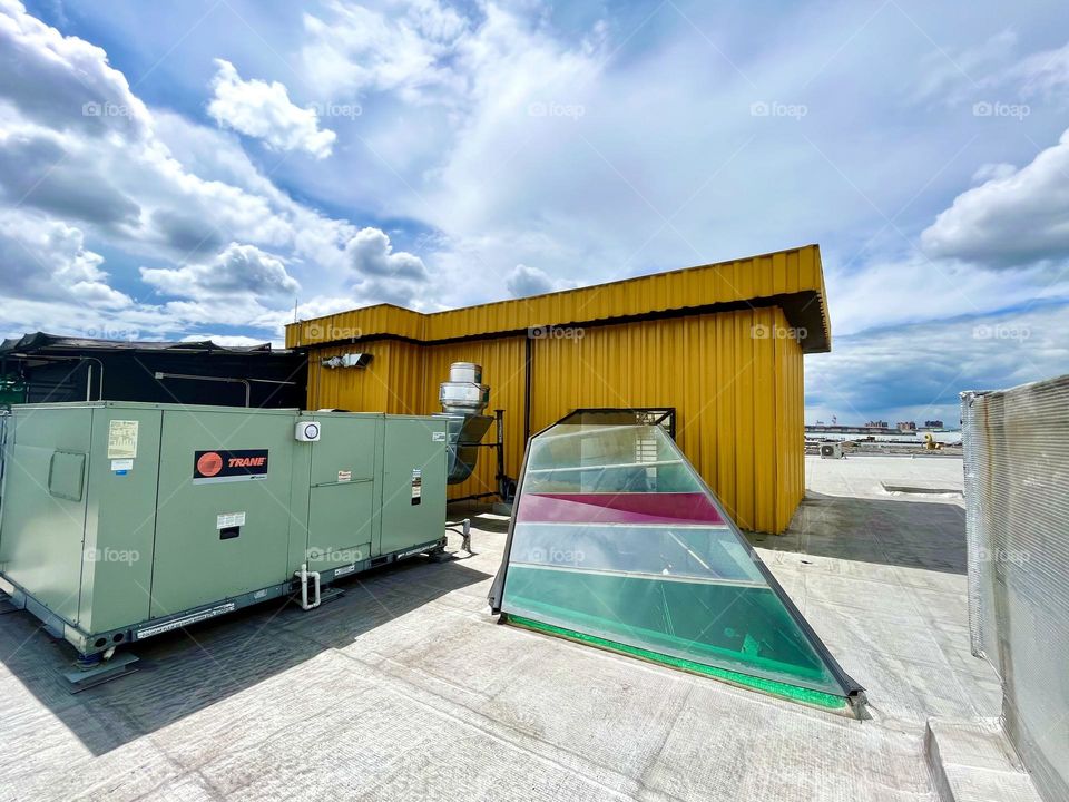 A yellow container in the rooftop in a cloudy day