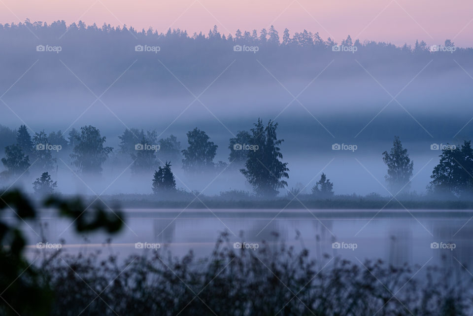Hazy summer evening by a lake in Western Finland