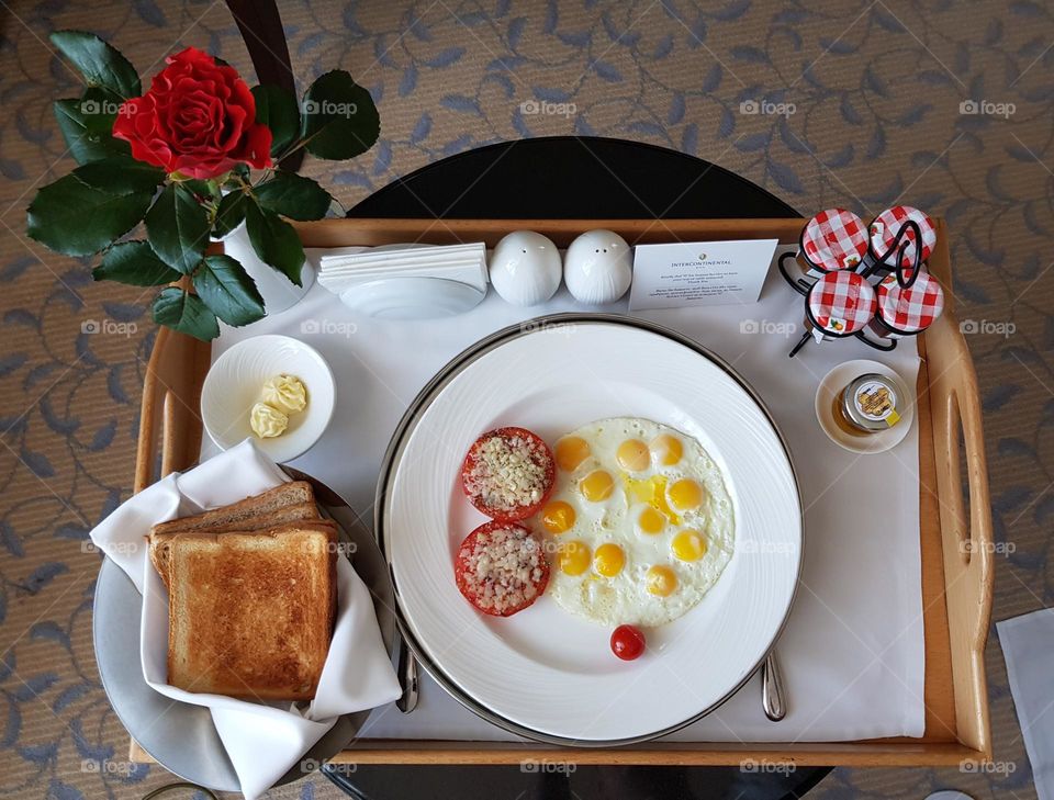 View on a delicious breakfast table with quail eggs, tomato and toast