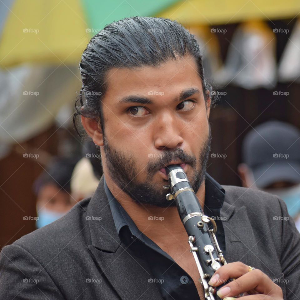 Man playing music during hindu festival 