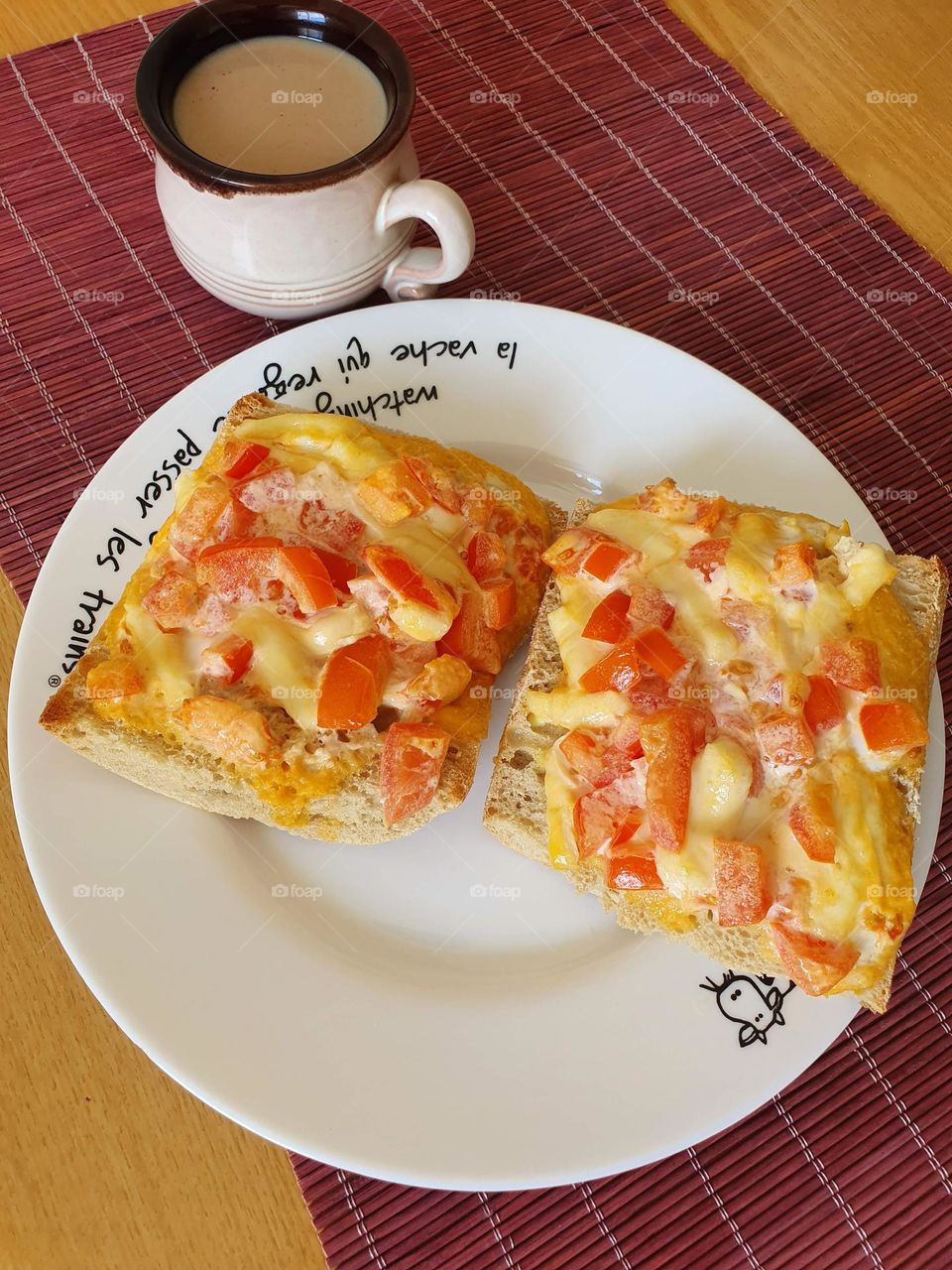 Cheese and tomato sandwiches with a cup of coffee.