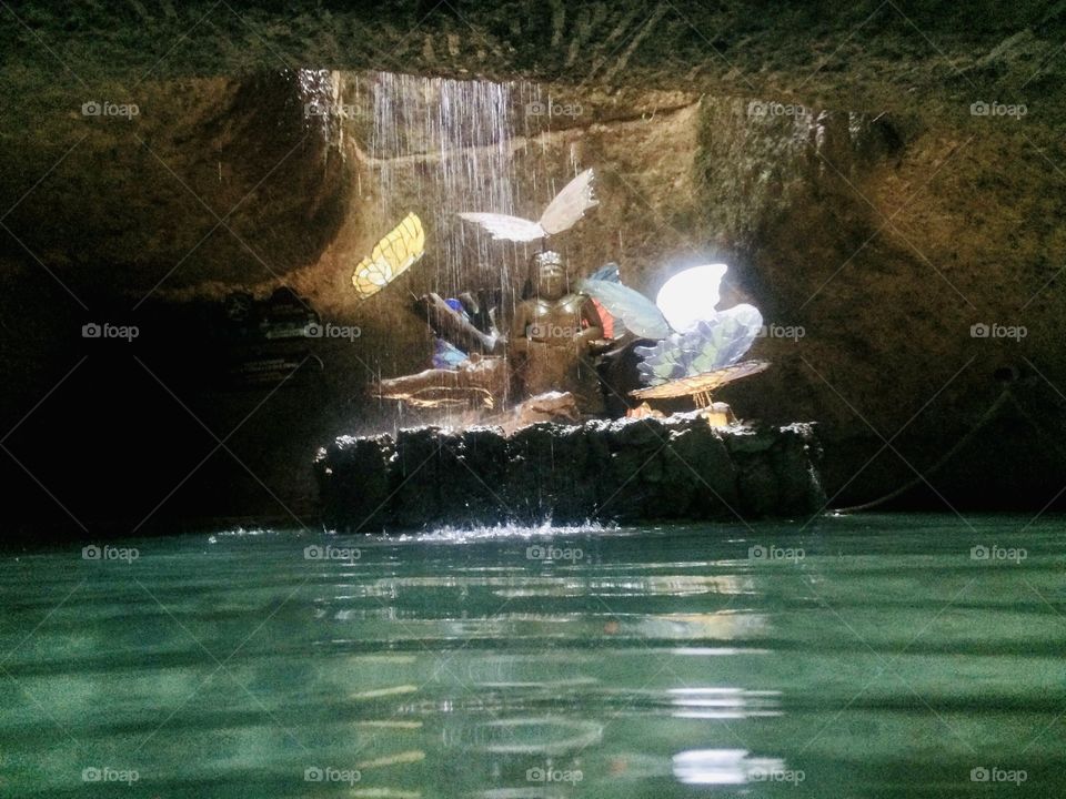 A natural underwater spring with a man made statue to worship the water gods in Mexico