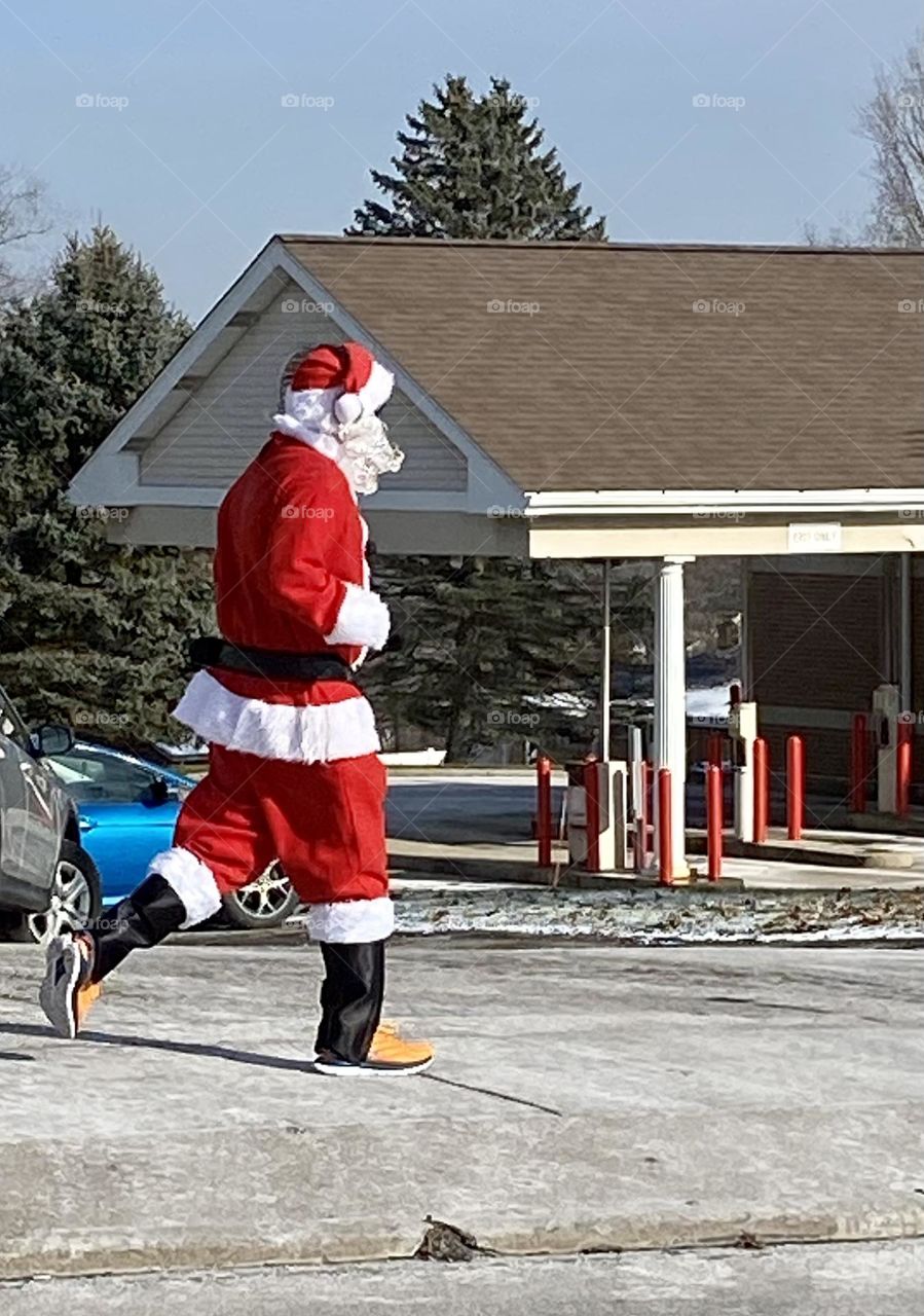 Santa Clause jogging past the drive thru bank