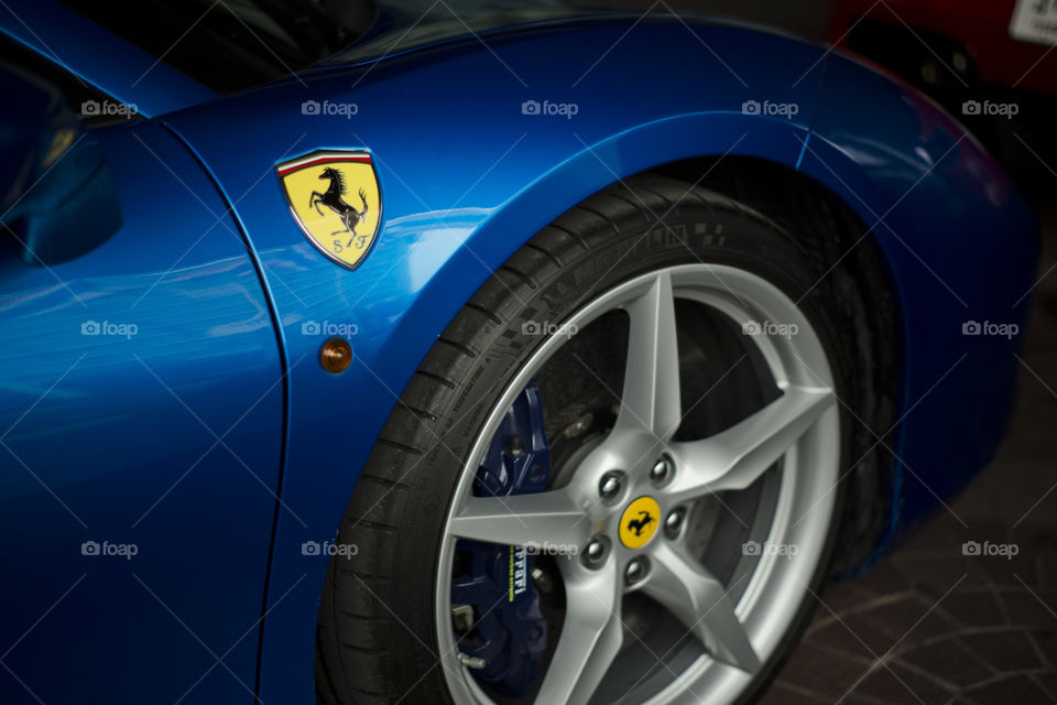 Blue Ferrari 488 spider coupe sports car 3.9 liter V8 twin turbo charged  (F154CB V8) close up logo and rim