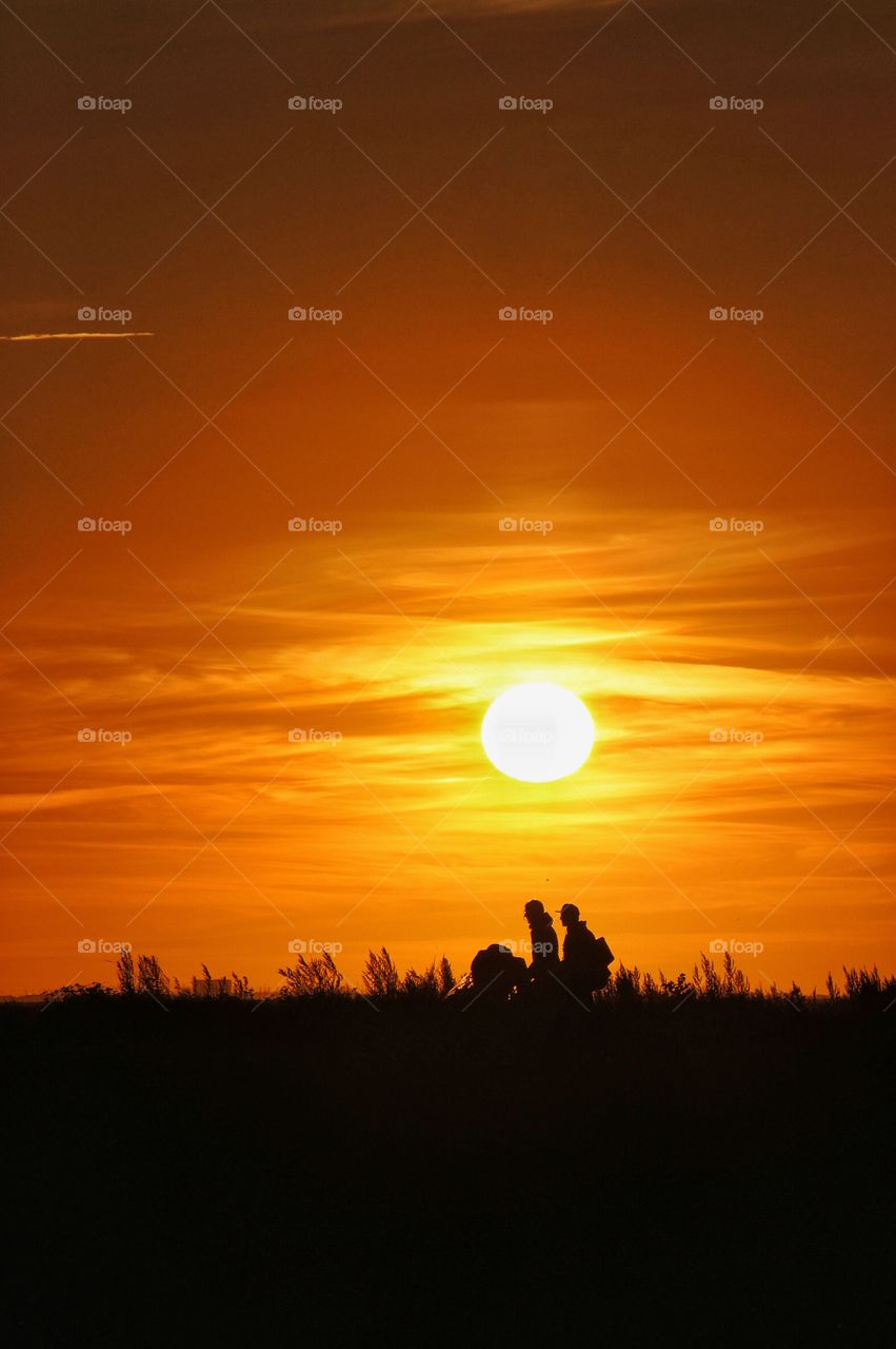 A people walking in the sunset