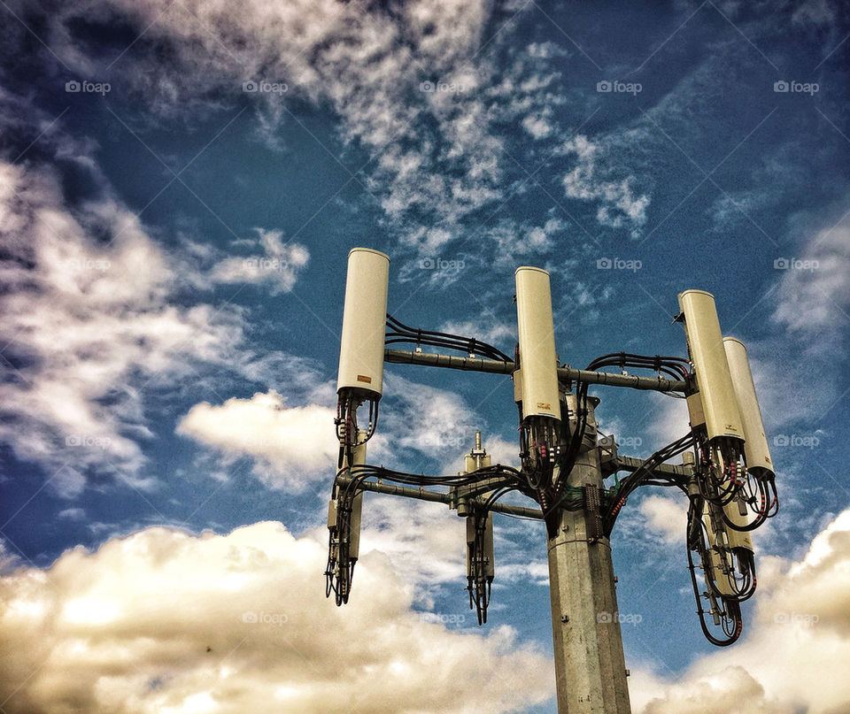 Cell phone relay station stands against a cloudy sky backdrop