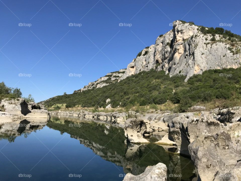 Reflection of cliff in water