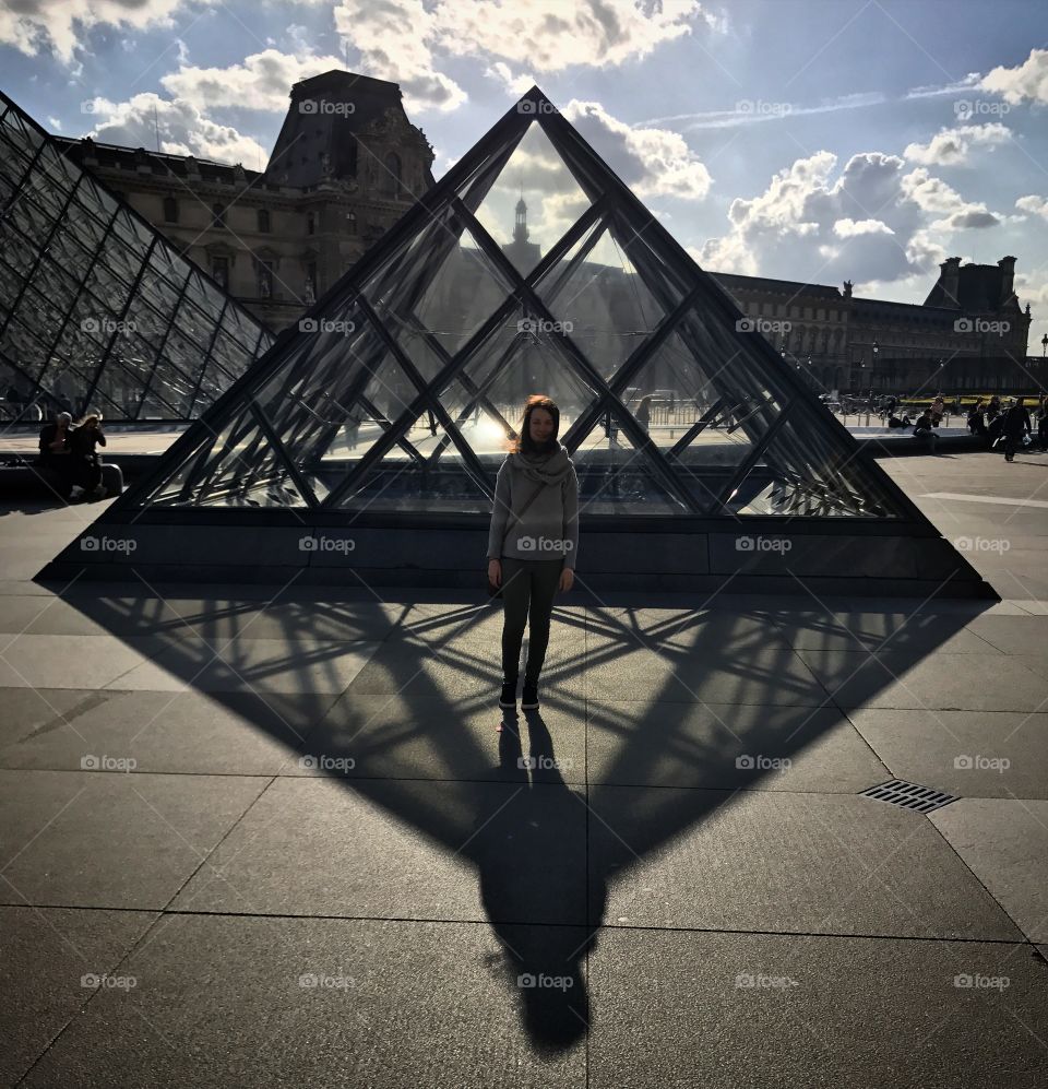 Girl at glass pyramid At Louvre. 