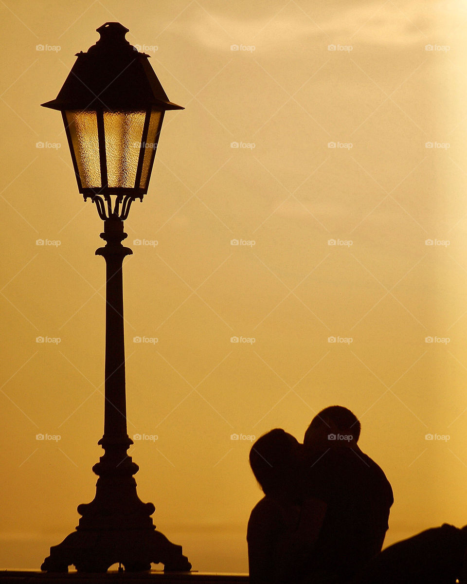 silhouette of a kissing couple at sunset