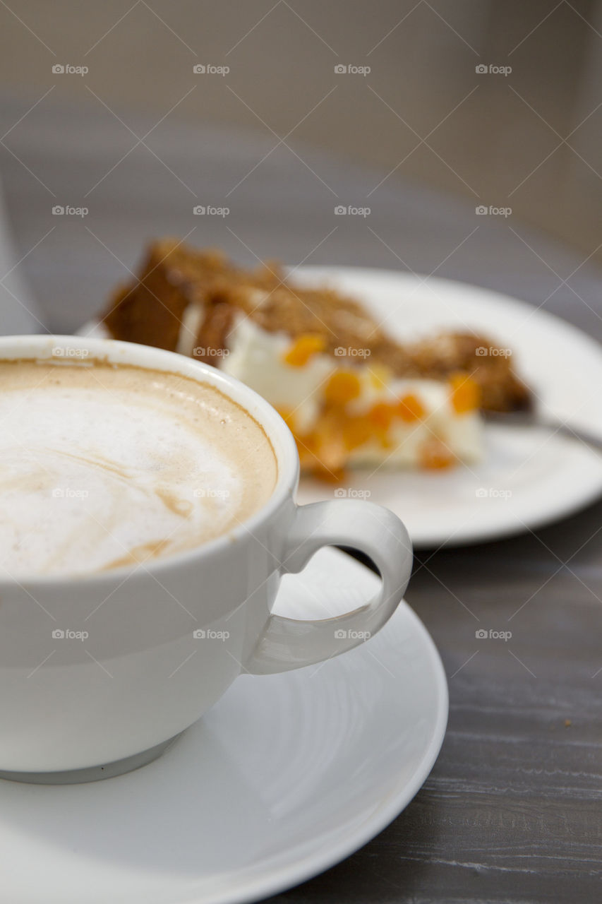 Coffee with cake on table