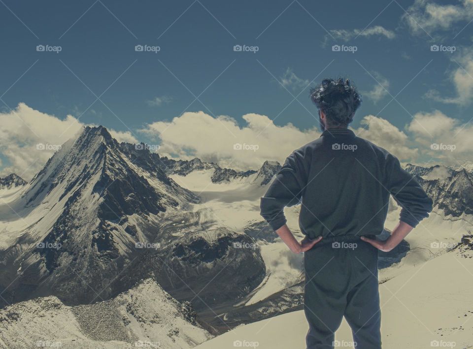 rear view of a man enjoying winter landscape scenery